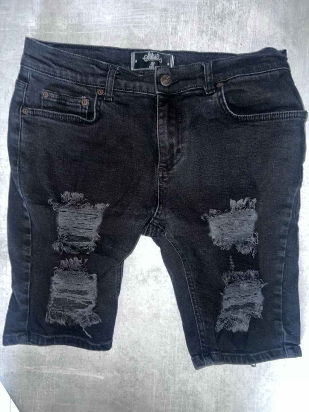 SikSilk Men's Distressed Denim Shorts. Styled in a washed black